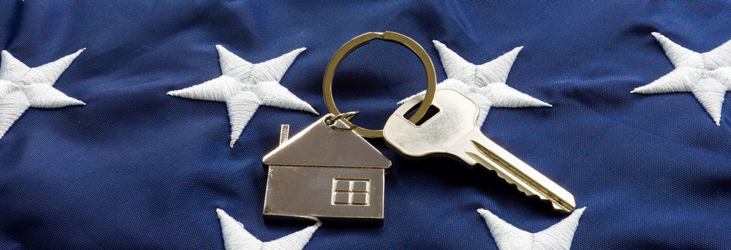 close up of stars on American flag with house keychain and key to home American VA Loans