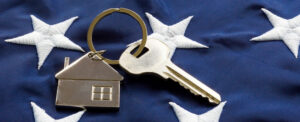 close up of stars on American flag with house keychain and key to home American VA Loans