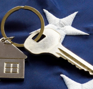 close up of stars on American flag with house keychain and key to home American VA Loans